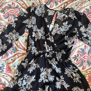 Black and white floral mini dress with V-neckline and long sleeves